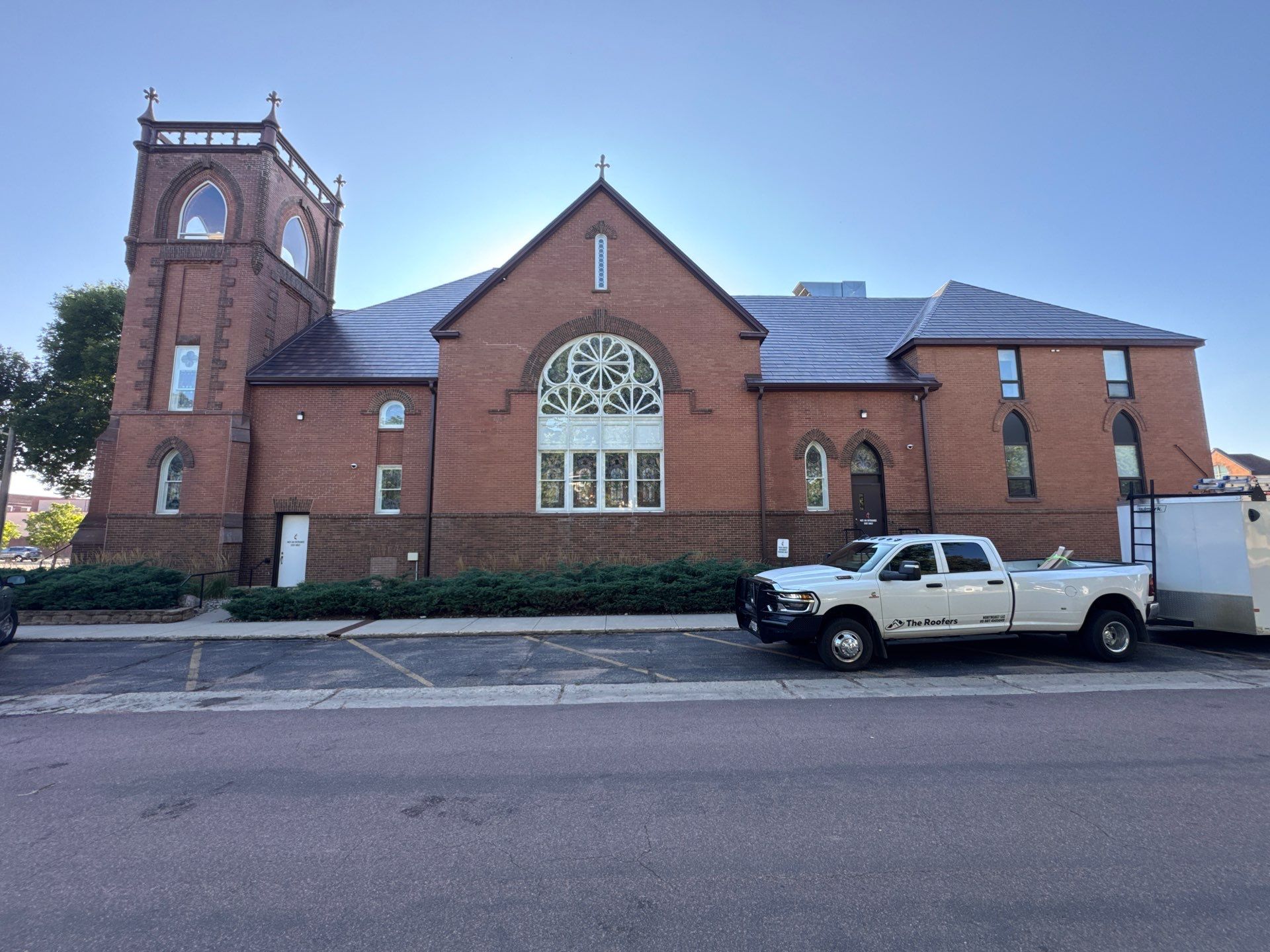 Completed metal shake roofing on First United Methodist Church in Brookings, with The Roofers truck outside